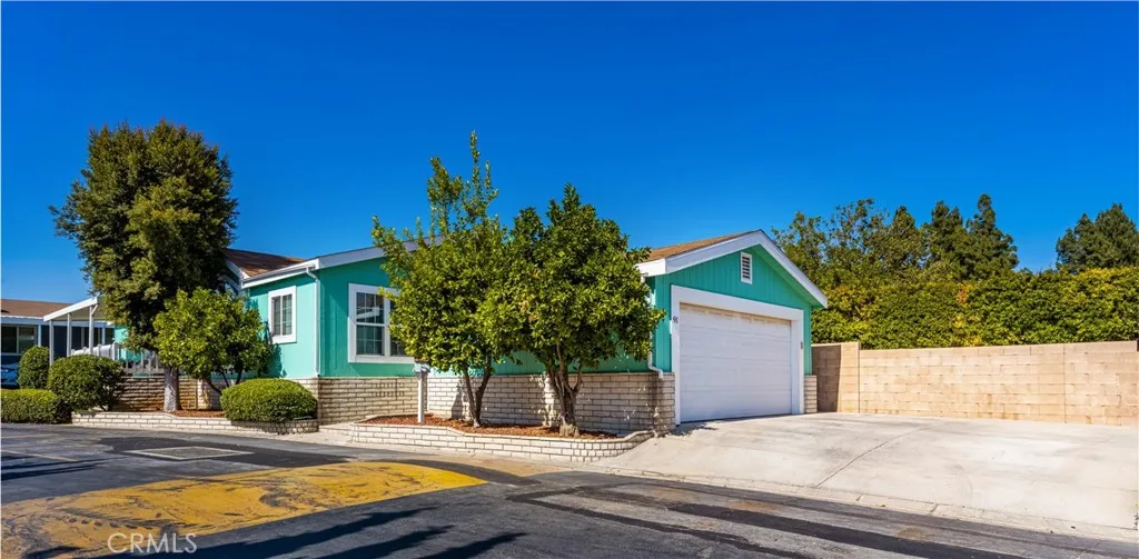 1051 Site, Unit 91 Brea, CA 92821 - Photo 4 of 32 a view of a house with backyard and trees