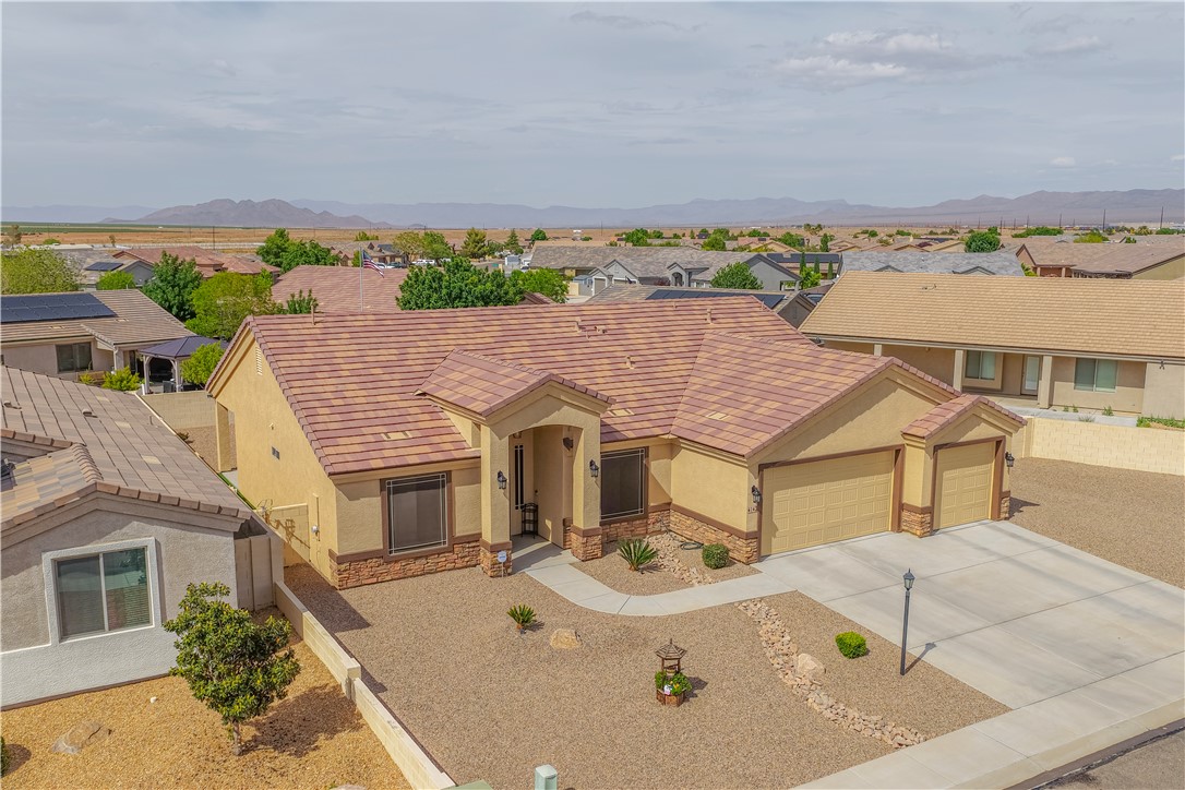 4143 North Stampede Road Kingman, AZ 86401 - Photo 2 of 42 Southwestern-style residence featuring a tile roof and stucco exterior
