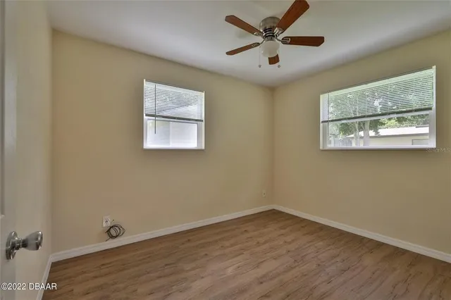 a view of an empty room with a painting on the wall