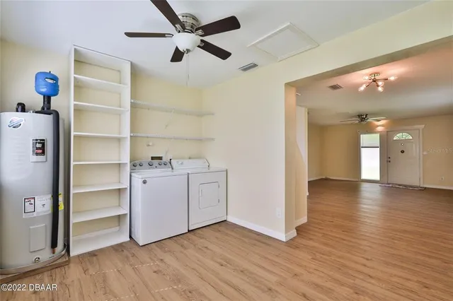 a view of a hallway with wooden floor and a cabinet