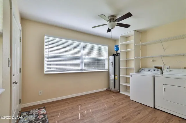 a view of a livingroom with wooden floor and a ceiling fan