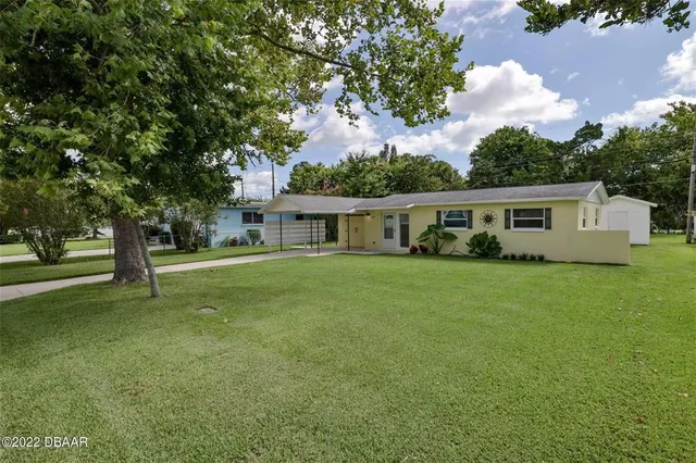 a front view of house with yard and trees