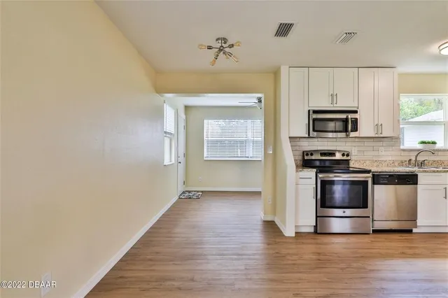 a kitchen with granite countertop a stove and a microwave