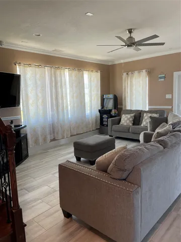 a living room with furniture and a flat screen tv