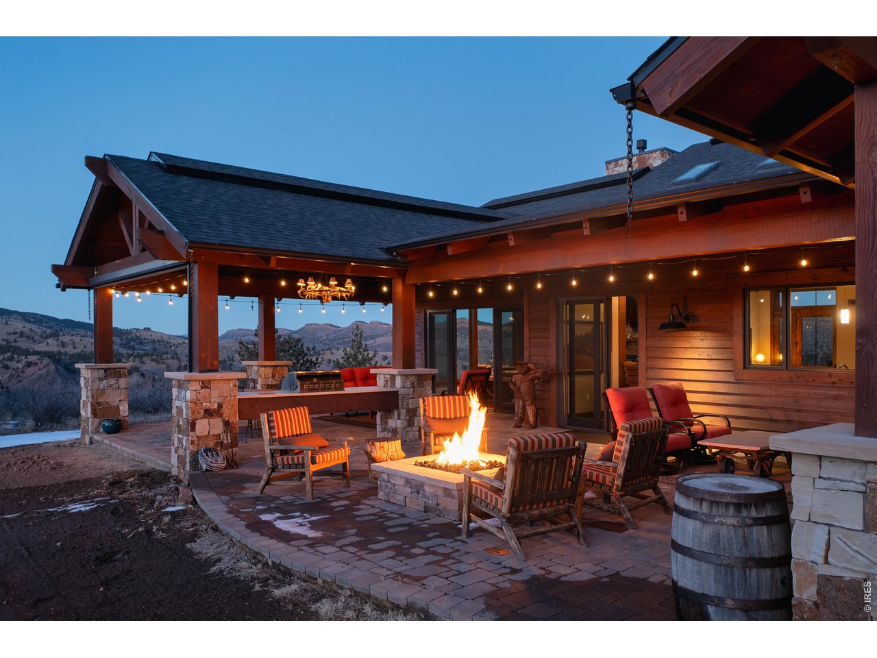 515 Indian Mountain Road Lyons, CO 80540 - Photo 11 of 40 a view of a patio with table and chairs under an umbrella