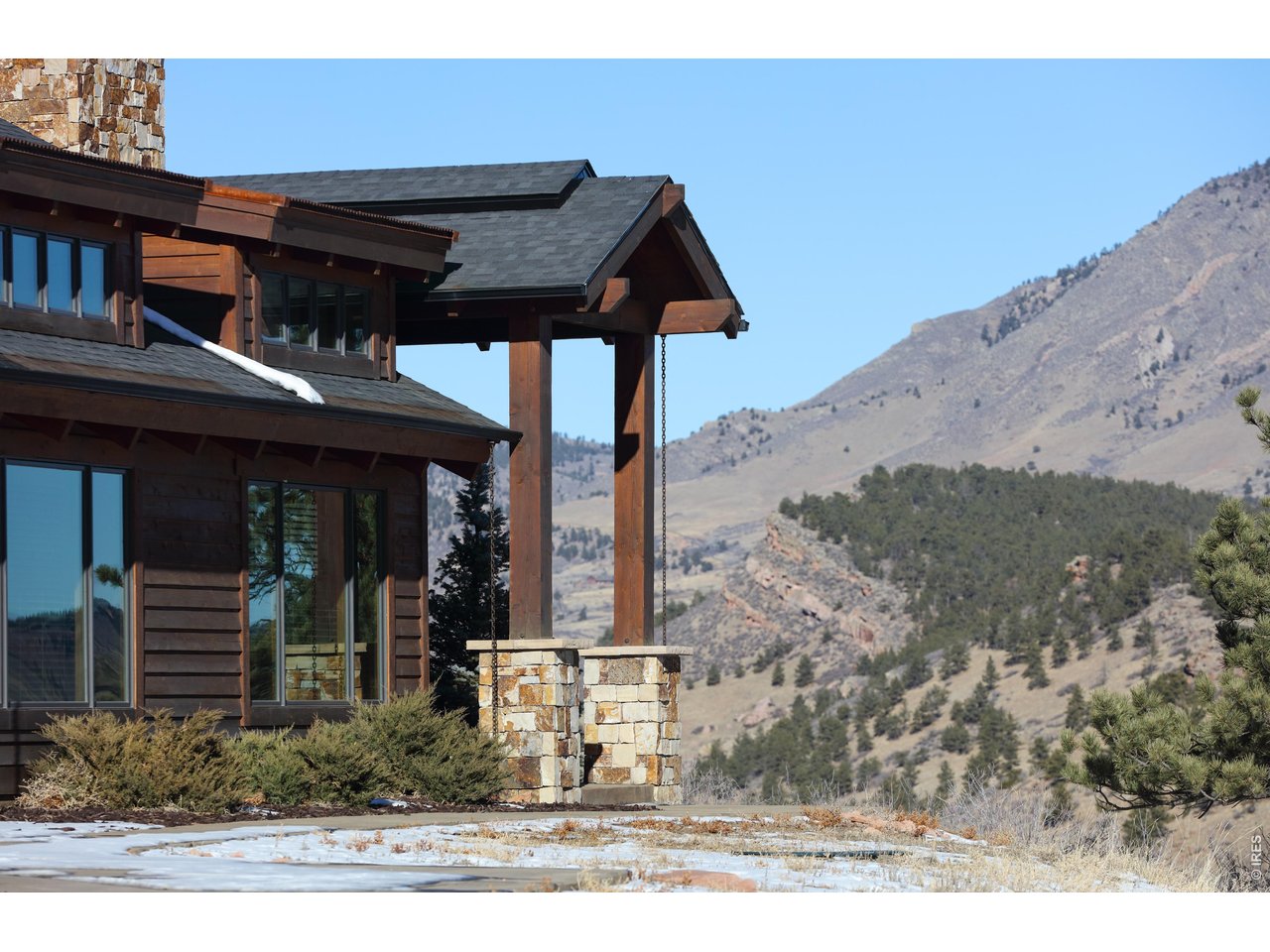 515 Indian Mountain Road Lyons, CO 80540 - Photo 5 of 40 a front view of a house with a yard
