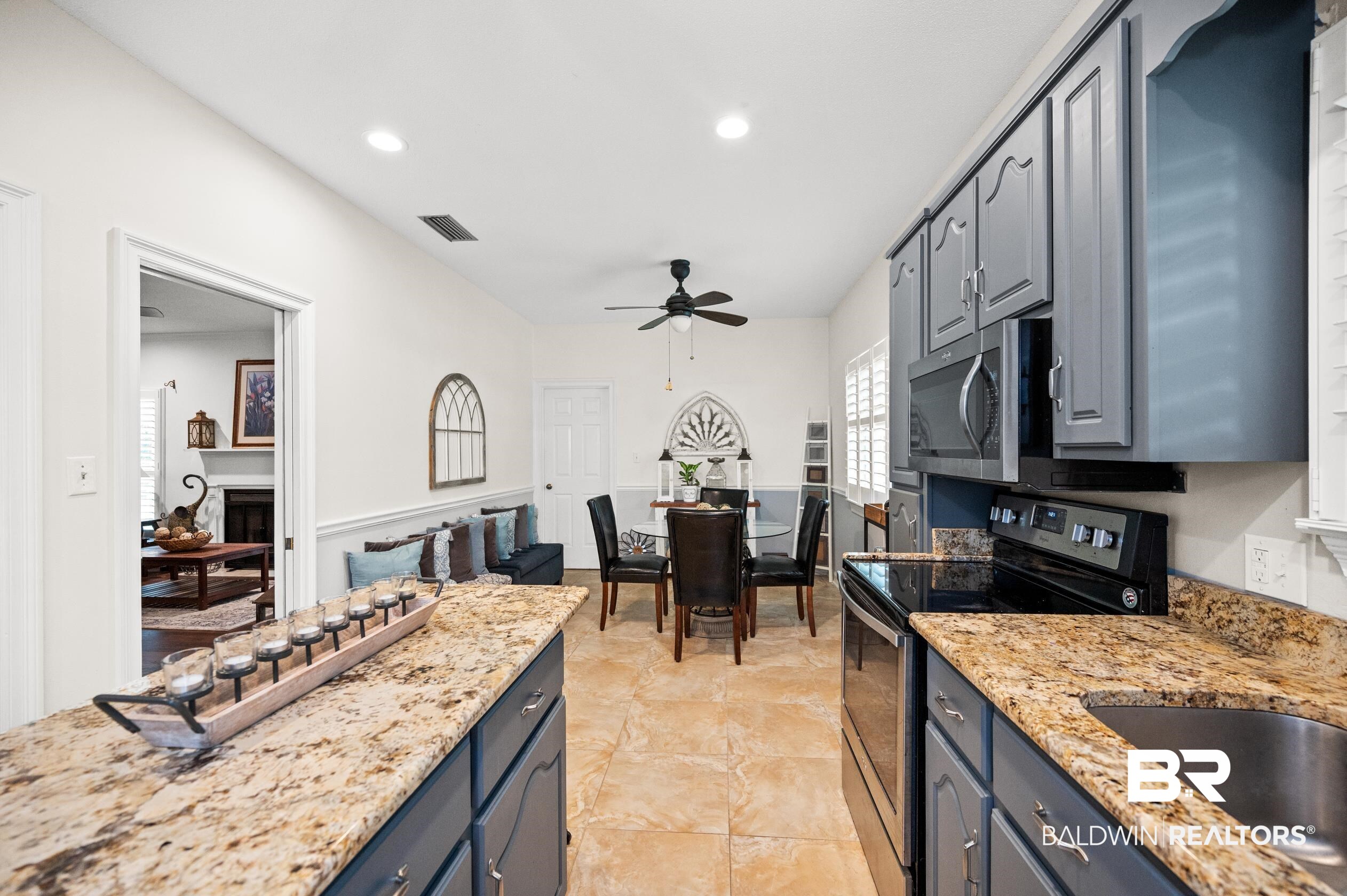 6638 Jackson Square Daphne, AL 36526 - Photo 15 of 62 Kitchen with electric stove, gray cabinets, light tile patterned floors, light stone countertops, and ceiling fan