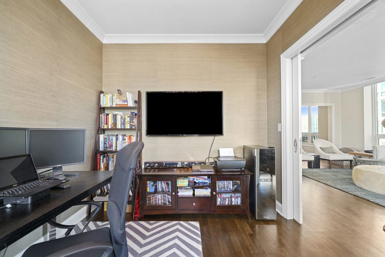 10 East Delaware Place, Unit 18E Chicago, IL 60611 - Photo 18 of 56 a living room with furniture and a flat screen tv