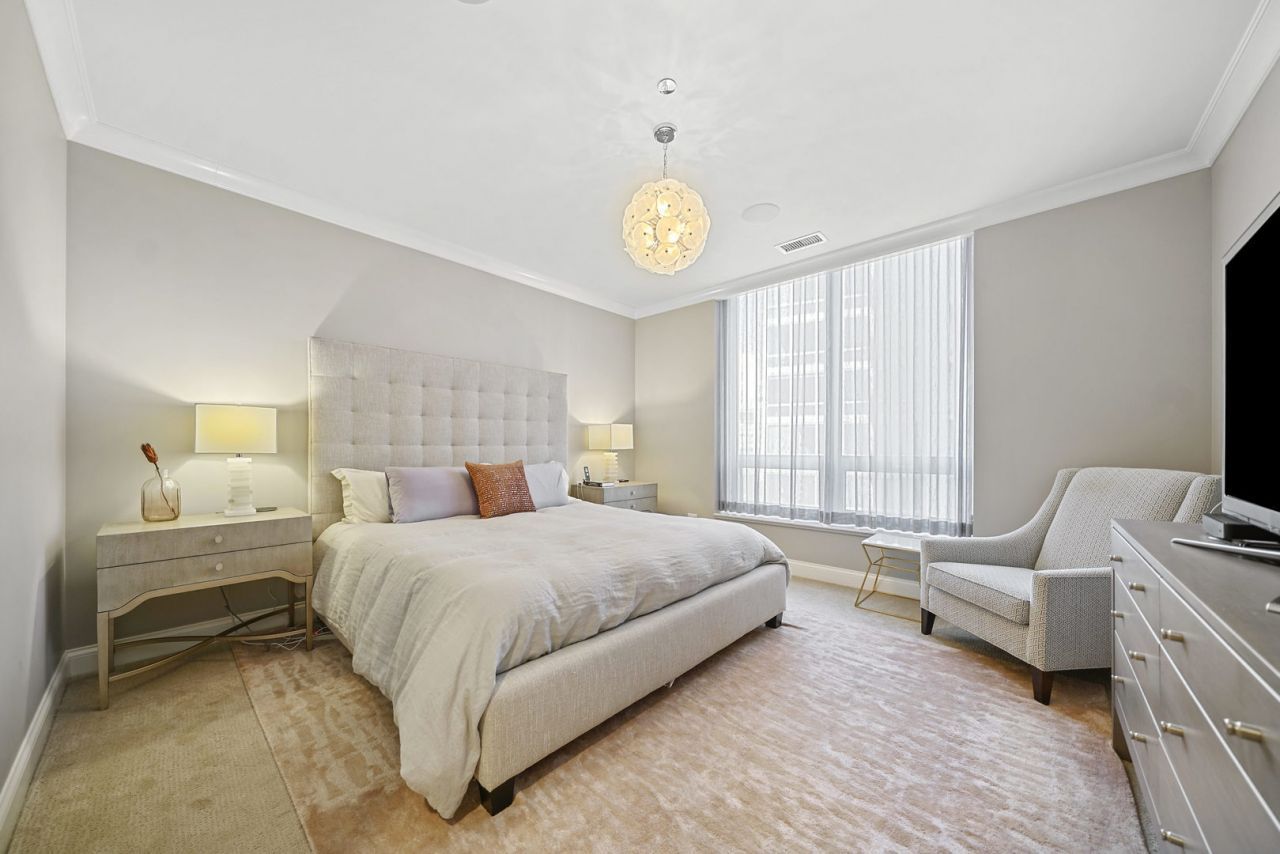 10 East Delaware Place, Unit 18E Chicago, IL 60611 - Photo 19 of 56 a bedroom with a bed and a window