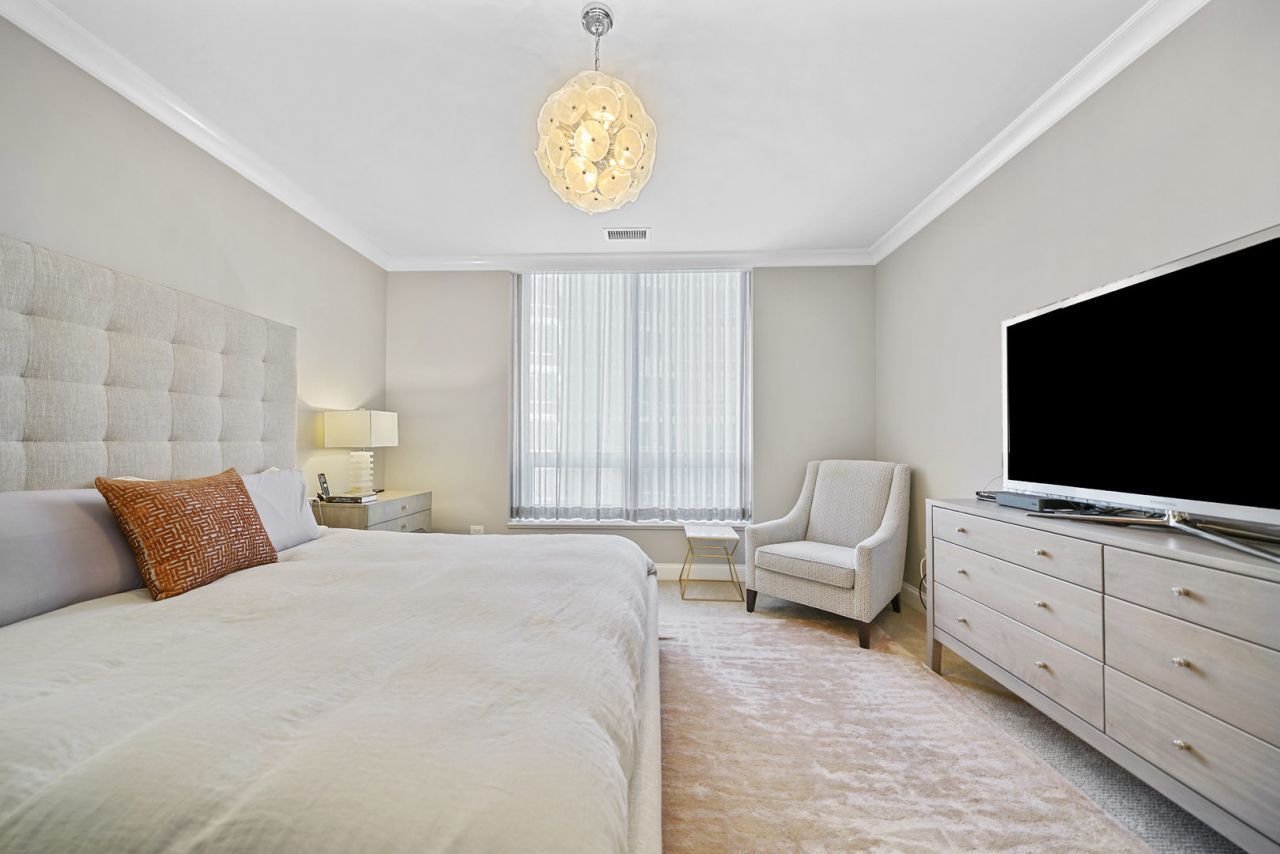 10 East Delaware Place, Unit 18E Chicago, IL 60611 - Photo 20 of 56 a bedroom with a bed and flat screen tv
