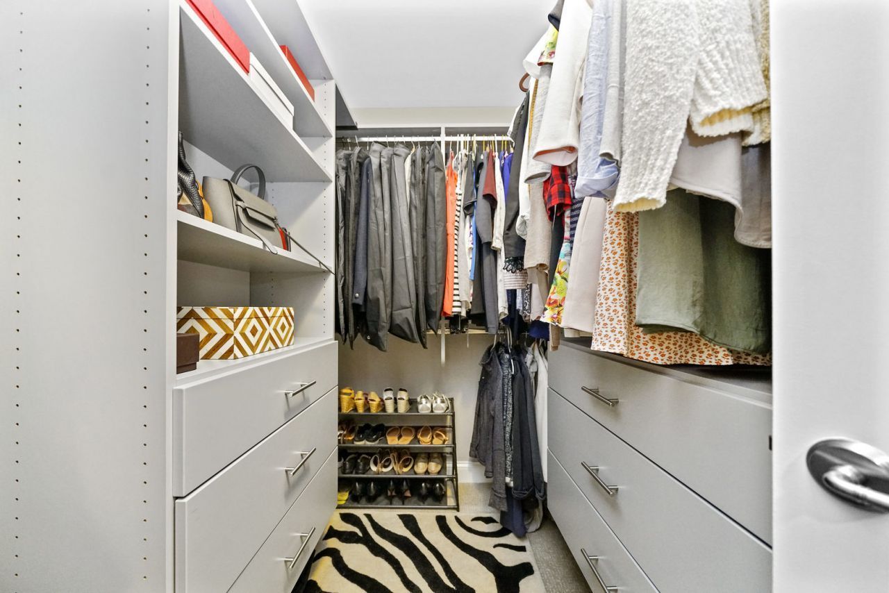 10 East Delaware Place, Unit 18E Chicago, IL 60611 - Photo 22 of 56 a view of walk in closet with clothes and shoes