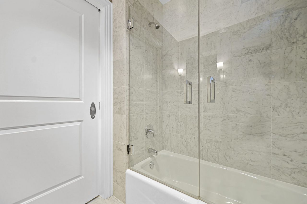 10 East Delaware Place, Unit 18E Chicago, IL 60611 - Photo 29 of 56 a bathroom with a bathtub and a shower