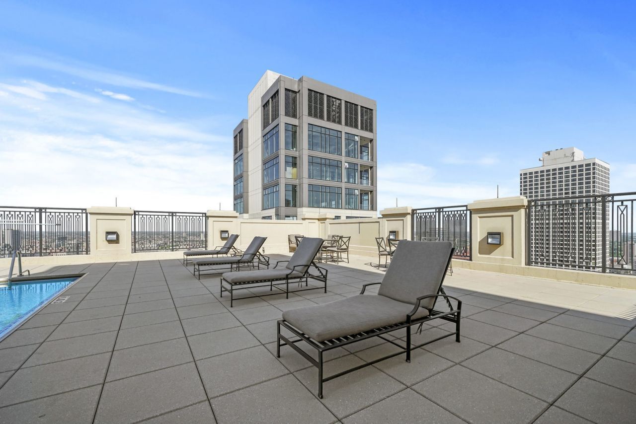 10 East Delaware Place, Unit 18E Chicago, IL 60611 - Photo 39 of 56 a roof deck with outdoor seating and city view