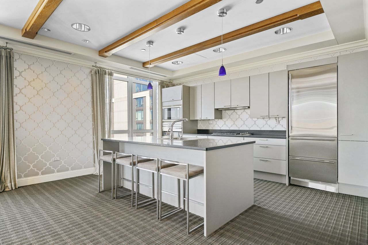 10 East Delaware Place, Unit 18E Chicago, IL 60611 - Photo 46 of 56 a kitchen with stainless steel appliances granite countertop a stove a sink and a refrigerator