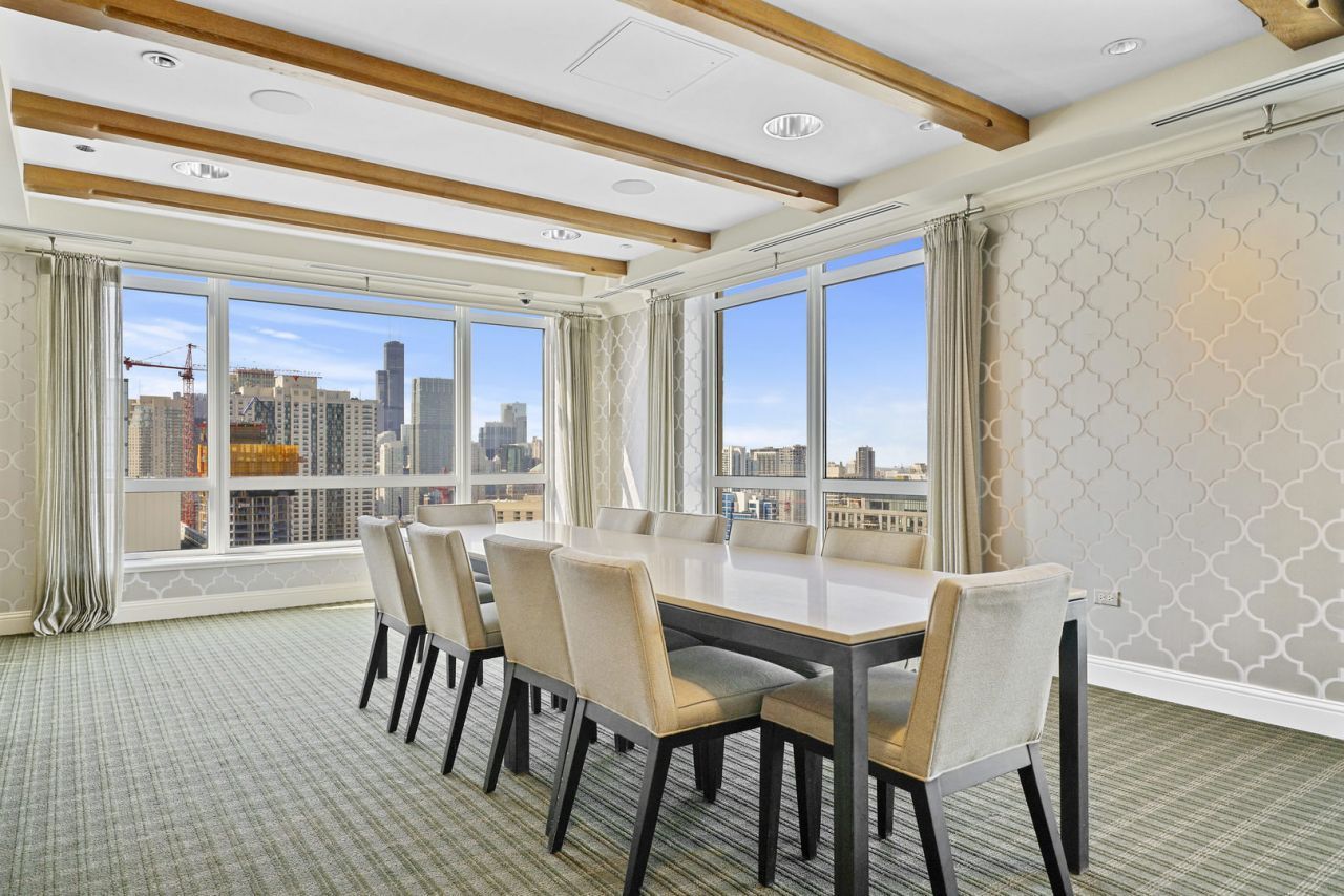 10 East Delaware Place, Unit 18E Chicago, IL 60611 - Photo 47 of 56 a dining room with furniture wooden floor and a chandelier