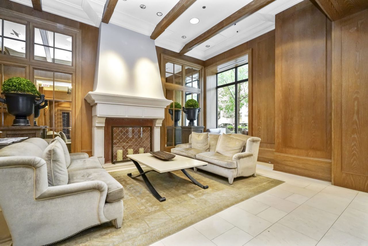 10 East Delaware Place, Unit 18E Chicago, IL 60611 - Photo 55 of 56 a living room with furniture and a fireplace