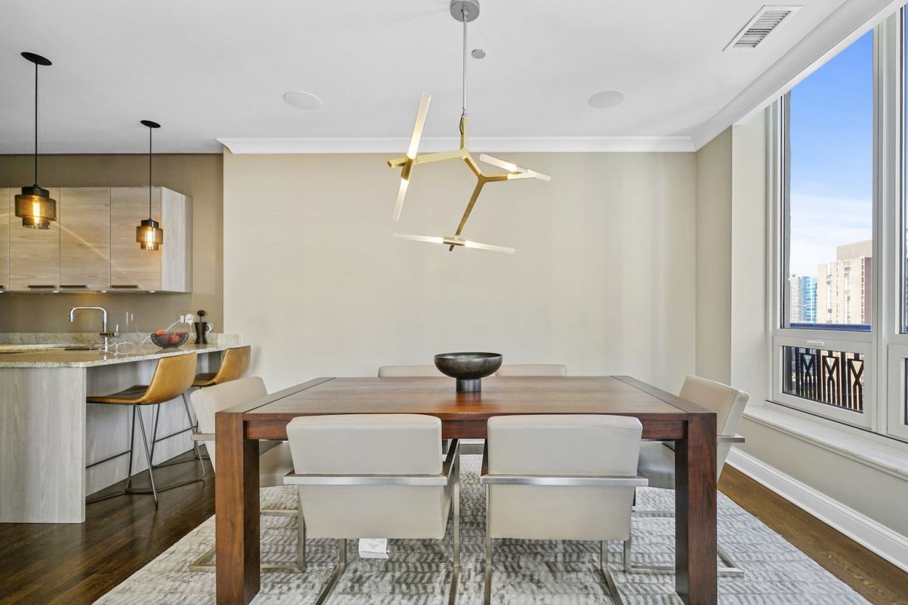 10 East Delaware Place, Unit 18E Chicago, IL 60611 - Photo 8 of 56 a view of a dining room with furniture and a chandelier