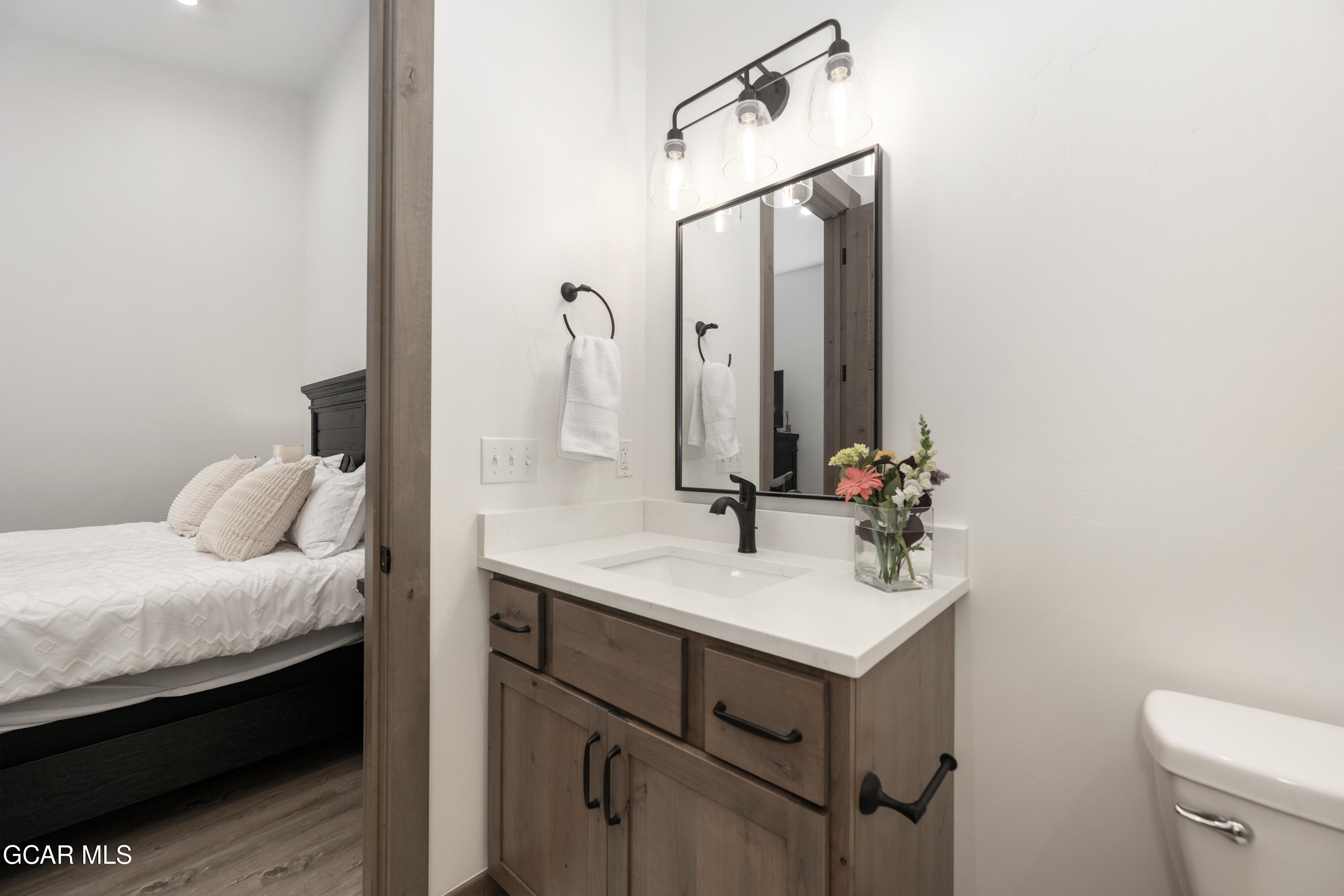 96 Meadow Trail, Unit G304 Fraser, CO 80442 - Photo 20 of 37 a bathroom with a sink vanity and a mirror