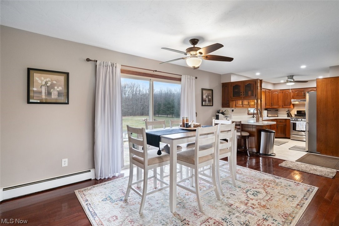 8221 Stone Road Medina, OH 44256 - Photo 7 of 35 Dining room featuring ceiling fan, hardwood floors, and baseboard heating