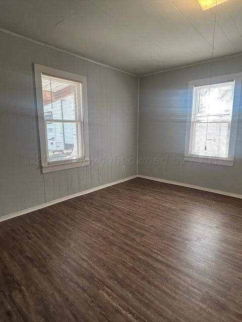 810 South Sweetwater Street Wheeler, TX 79096 - Photo 11 of 14 an empty room with wooden floor and windows