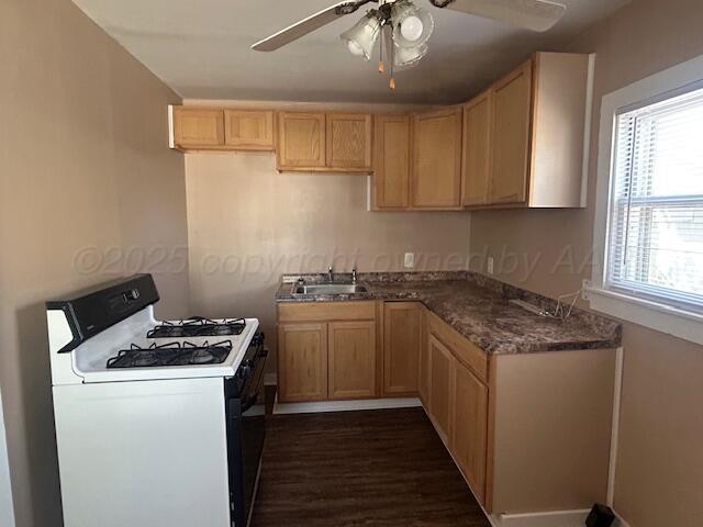 810 South Sweetwater Street Wheeler, TX 79096 - Photo 2 of 14 a kitchen with granite countertop a sink a stove and cabinets