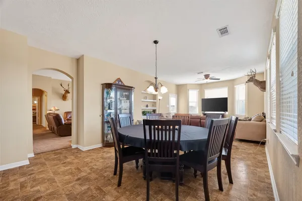 a living room with furniture ceiling fan and a window