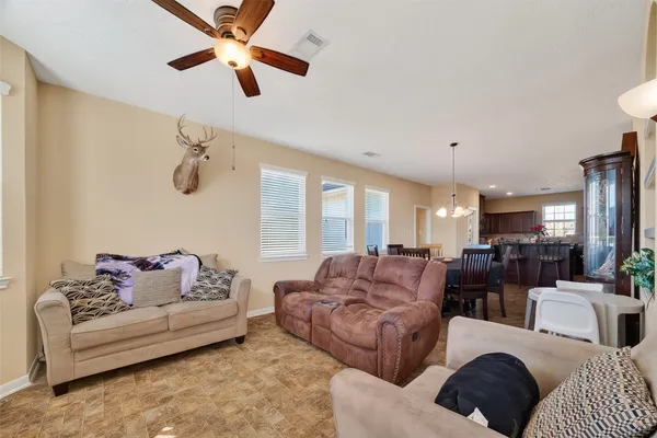 a kitchen with stainless steel appliances granite countertop a stove top oven a sink dishwasher a dining table and chairs