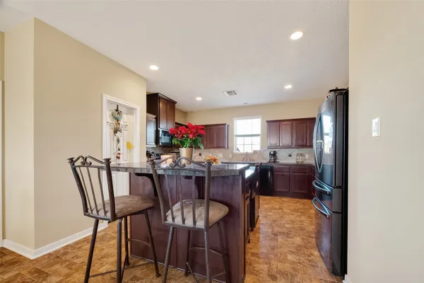 a bedroom with a bed and a couch next to a window