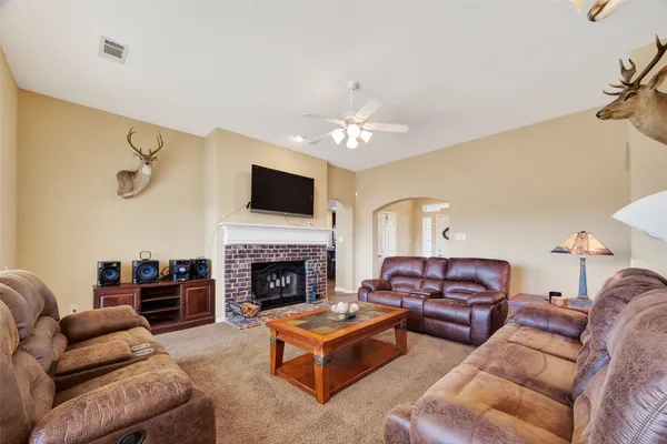 a dining room with furniture a chandelier and window