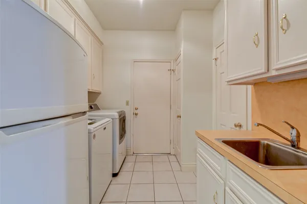a kitchen with kitchen island granite countertop a sink cabinets and wooden floor