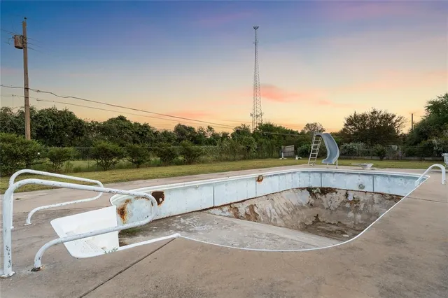 a view of a swimming pool with a back yard