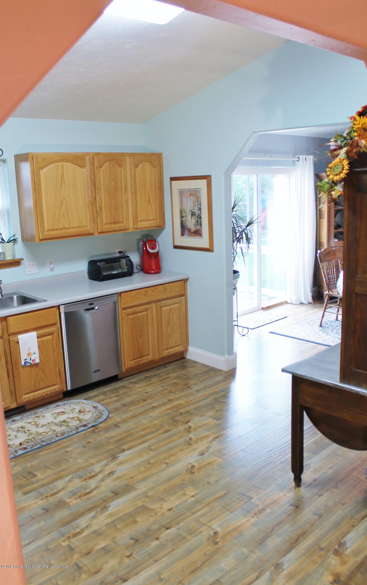 695 Birch Court Rifle, CO 81650 - Photo 33 of 46 a living room with stainless steel appliances furniture a kitchen view and wooden floor