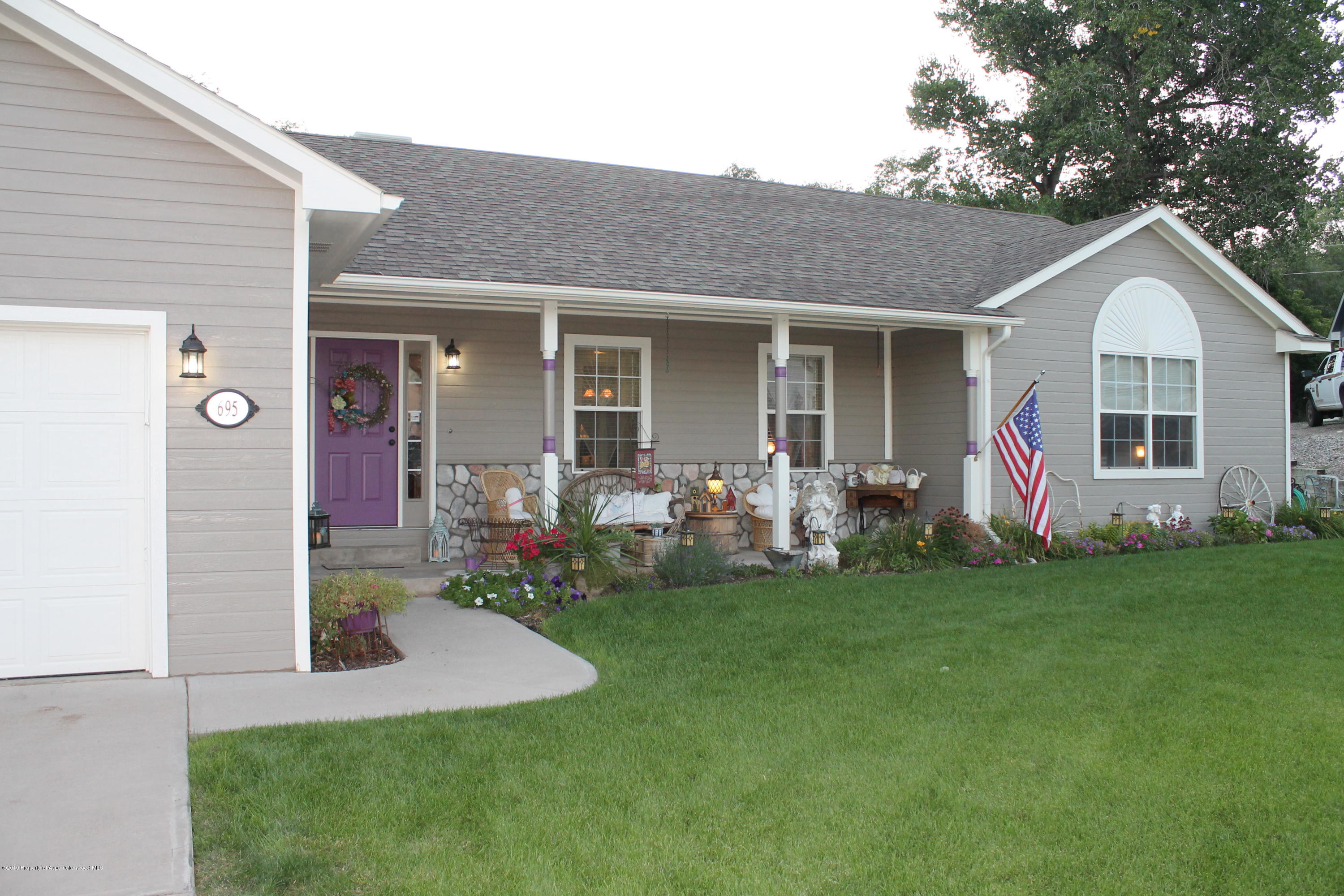 695 Birch Court Rifle, CO 81650 - Photo 4 of 46 a front view of house with yard and outdoor seating