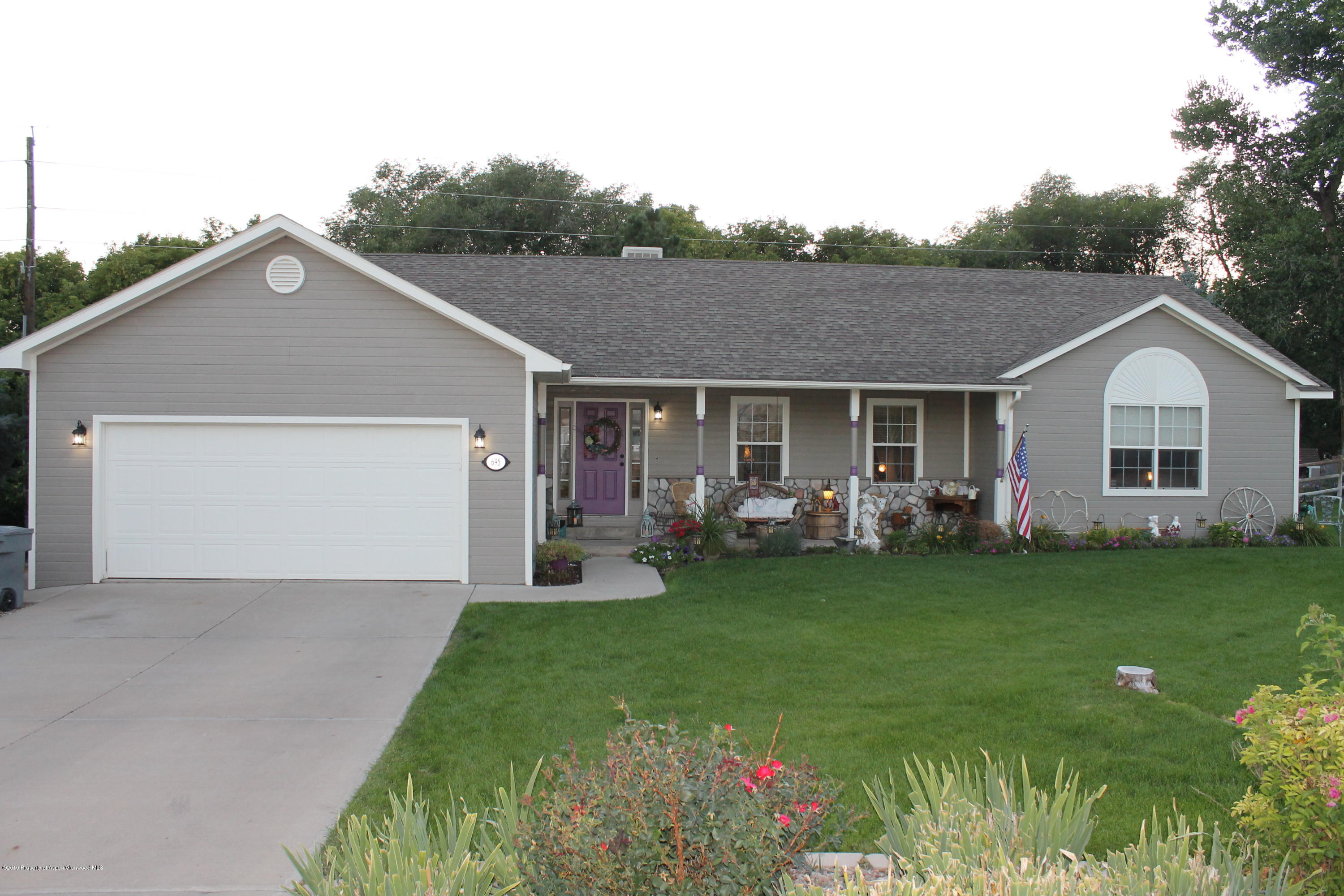 695 Birch Court Rifle, CO 81650 - Photo 46 of 46 a front view of a house with a garden and porch