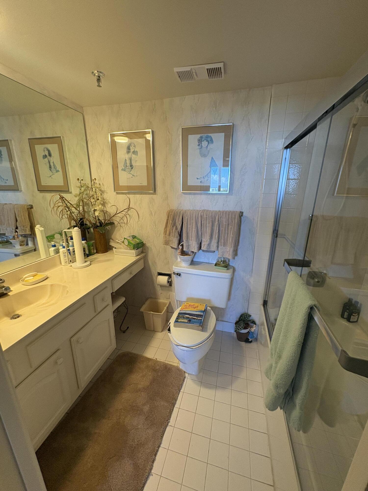 6895 Willow Wood Drive, Unit 1083 Boca Raton, FL 33434 - Photo 11 of 56 a bathroom with a sink mirror vanity and toilet