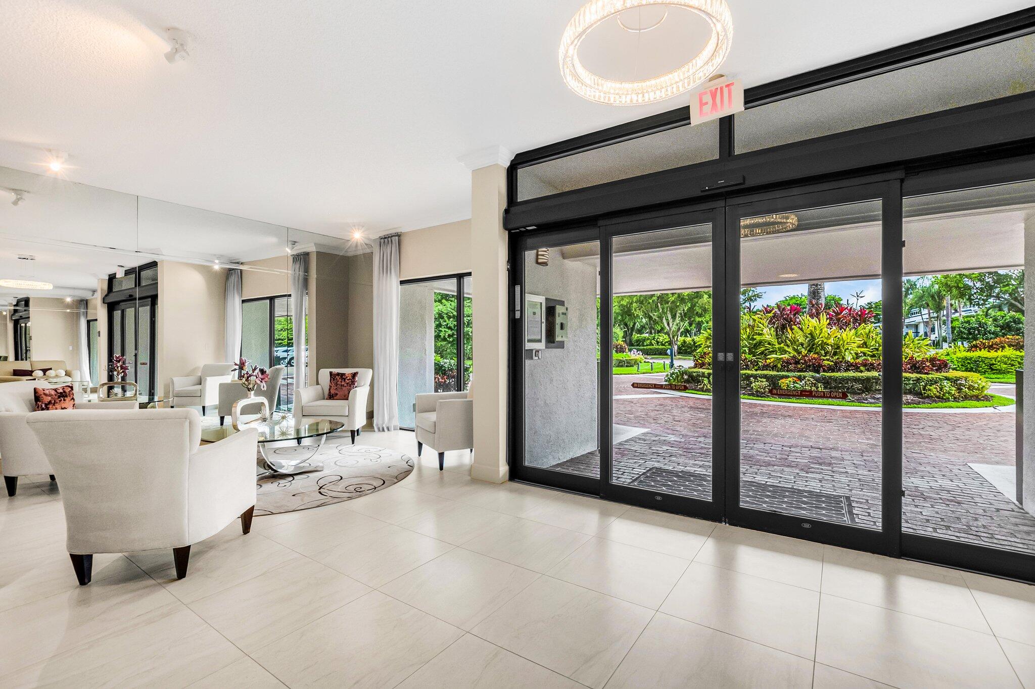 6895 Willow Wood Drive, Unit 1083 Boca Raton, FL 33434 - Photo 3 of 56 a living room with furniture and a large window