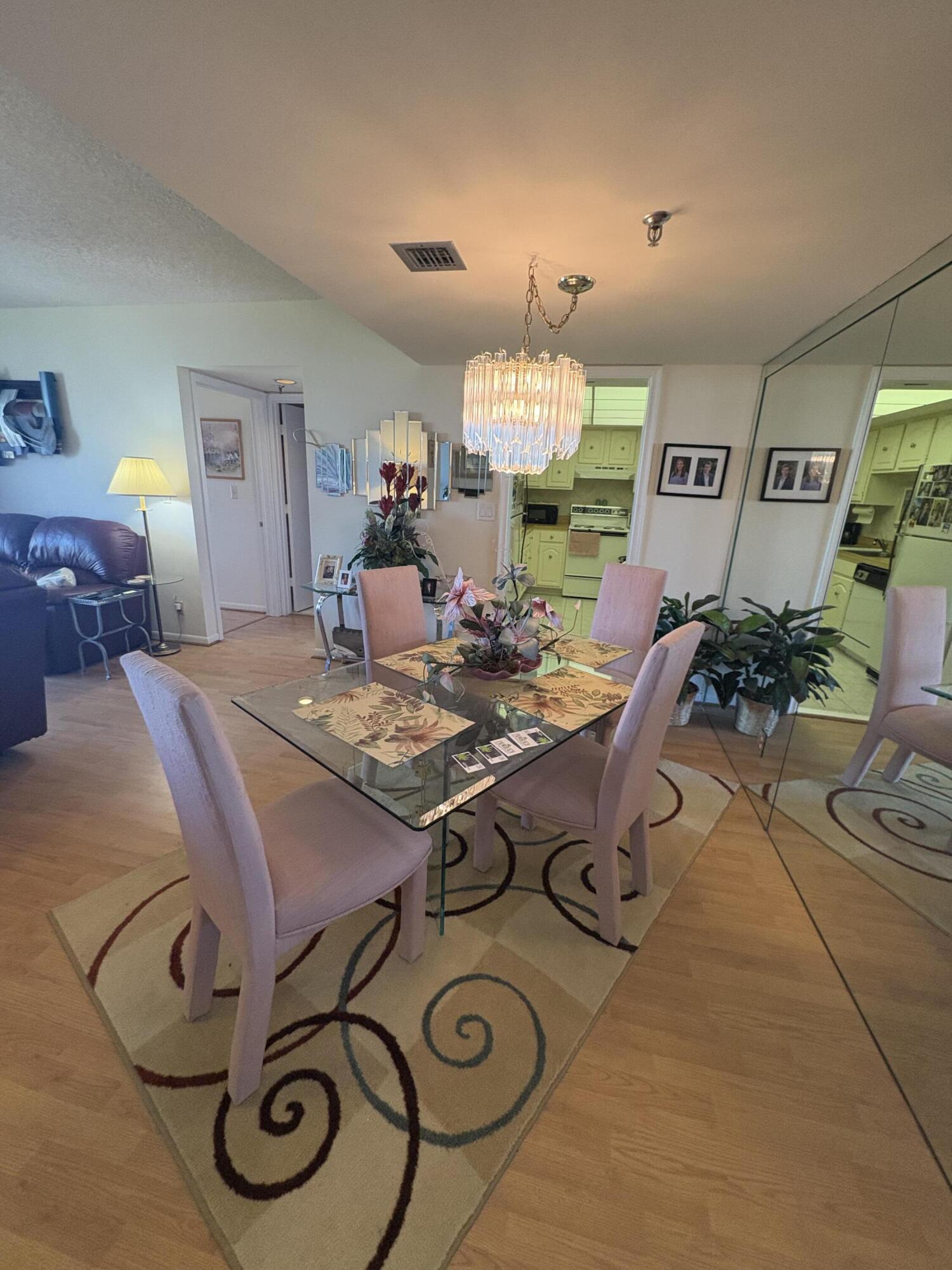 6895 Willow Wood Drive, Unit 1083 Boca Raton, FL 33434 - Photo 7 of 56 a view of a dining room with furniture
