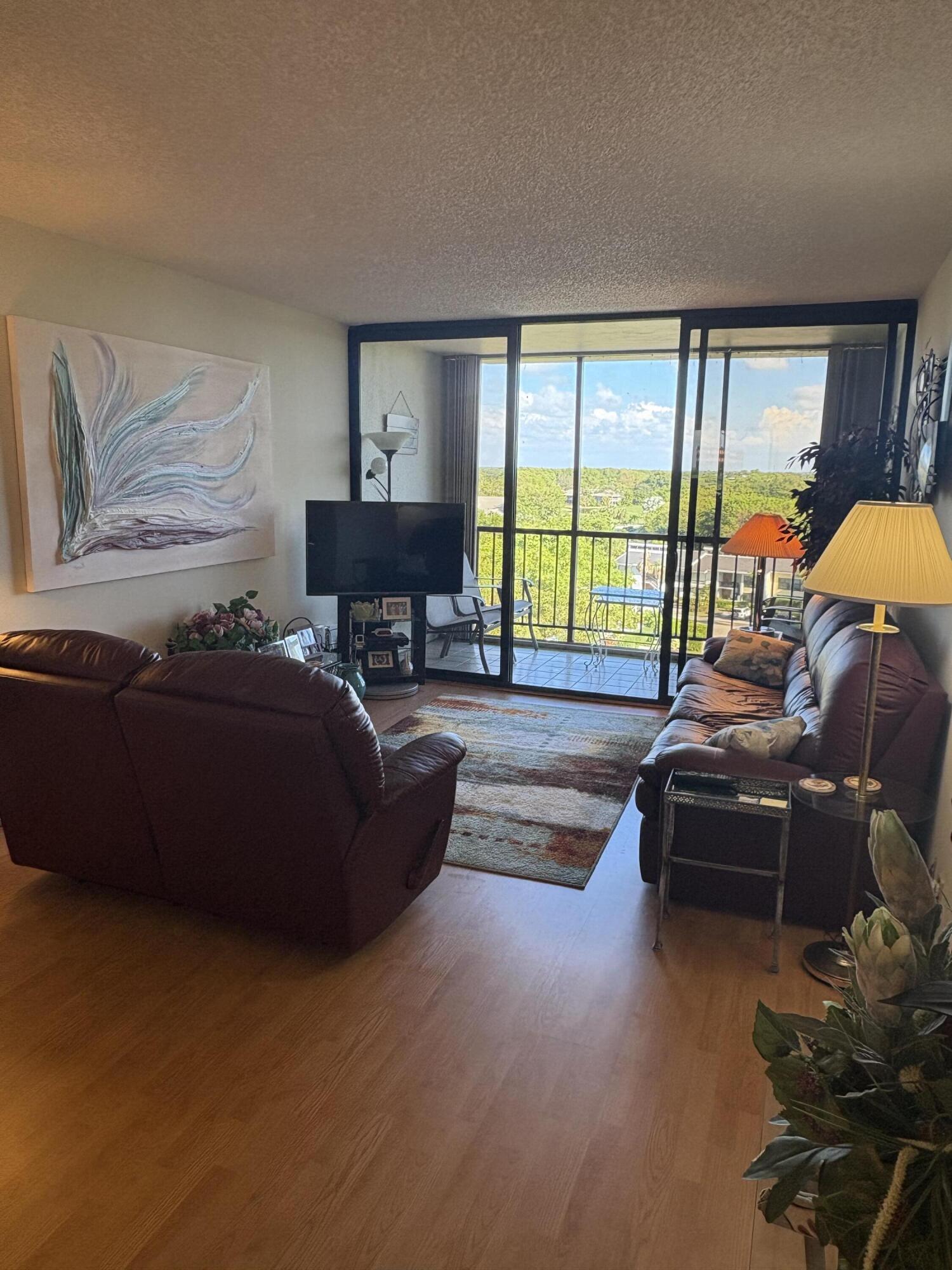 6895 Willow Wood Drive, Unit 1083 Boca Raton, FL 33434 - Photo 8 of 56 a living room with furniture and a large window