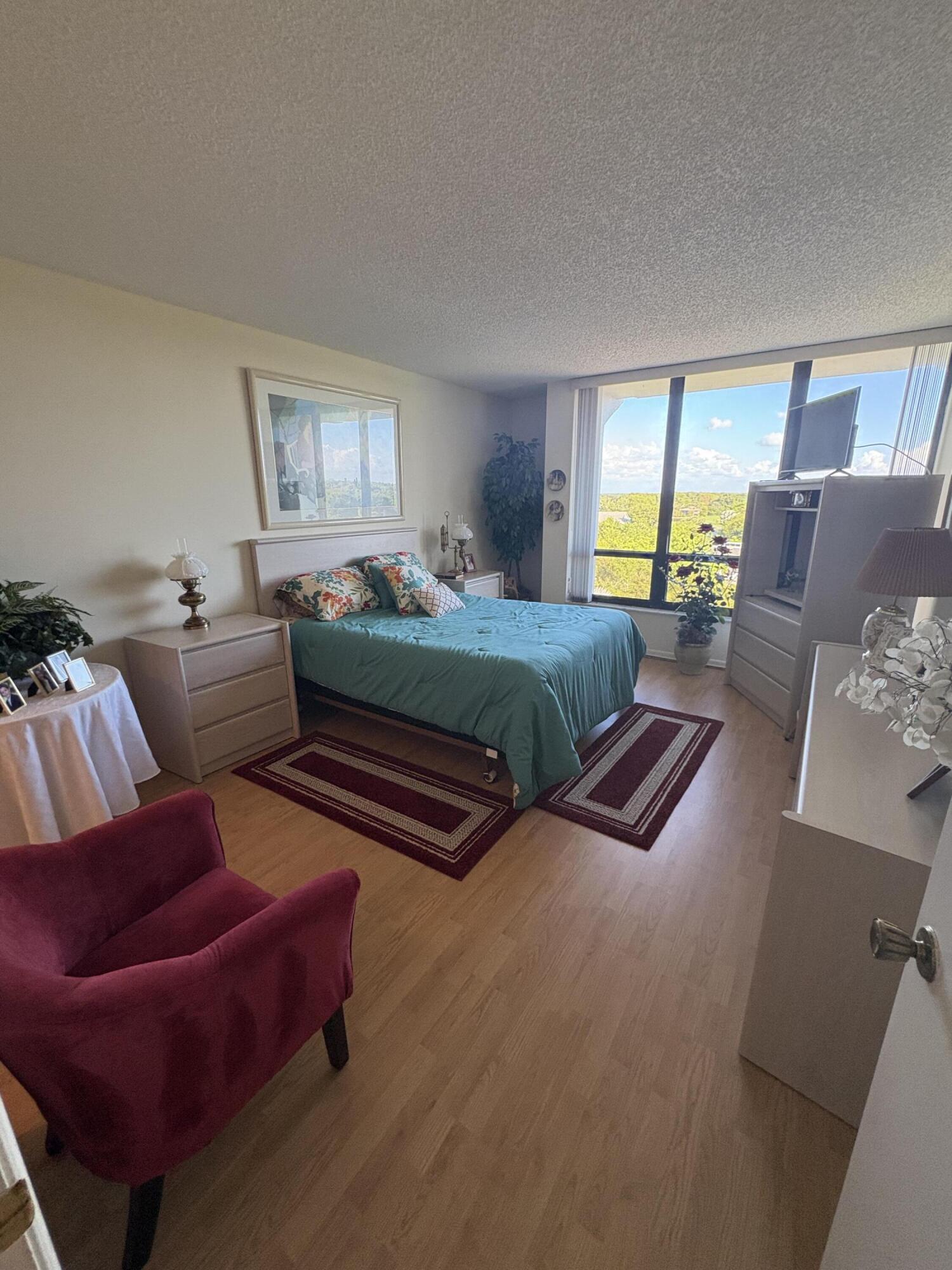 6895 Willow Wood Drive, Unit 1083 Boca Raton, FL 33434 - Photo 10 of 56 a bedroom with two beds and a couch