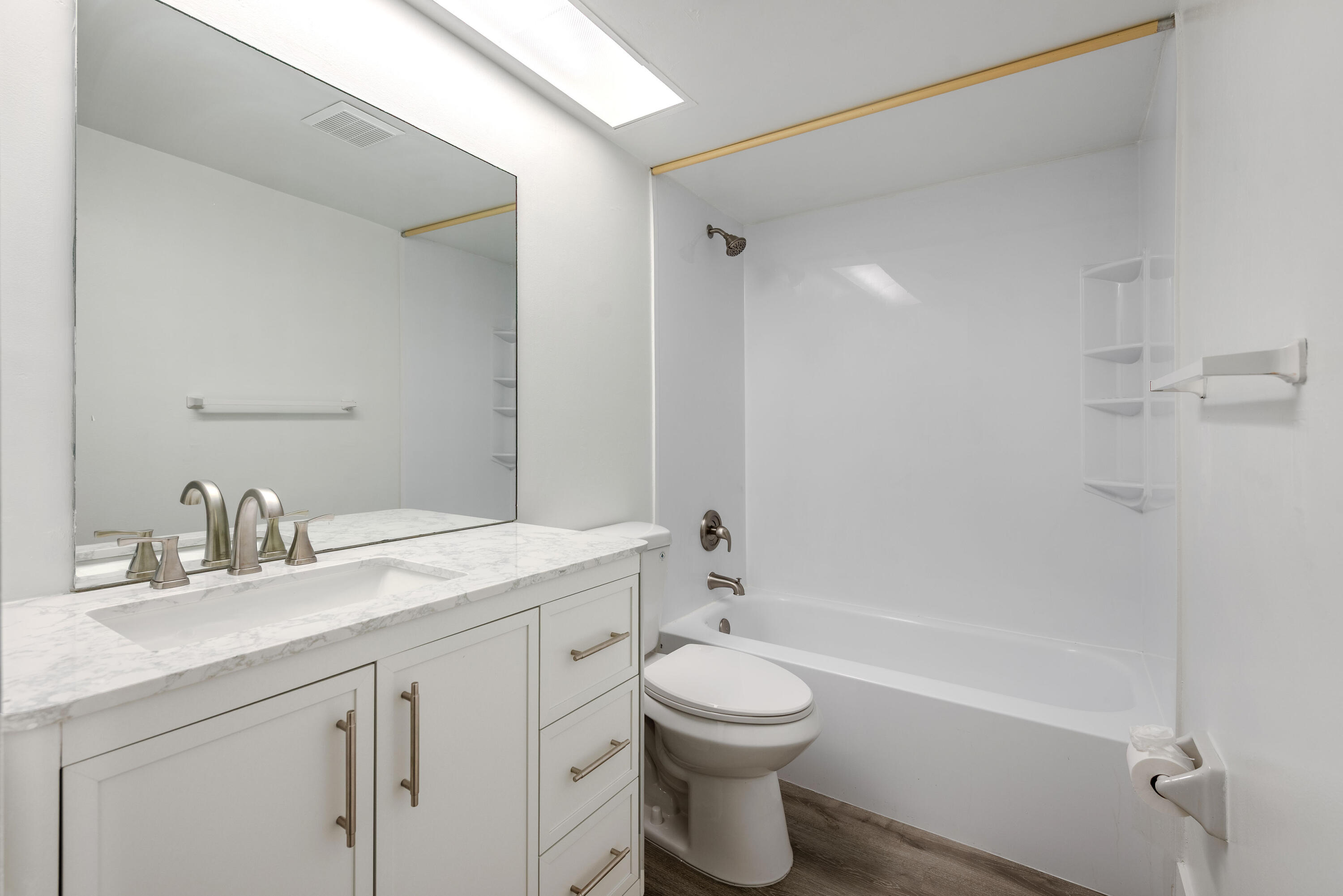 471 Kirk Road, Unit D West Palm Beach, FL 33406 - Photo 15 of 28 a bathroom with a toilet a sink a mirror a bathtub and vanity