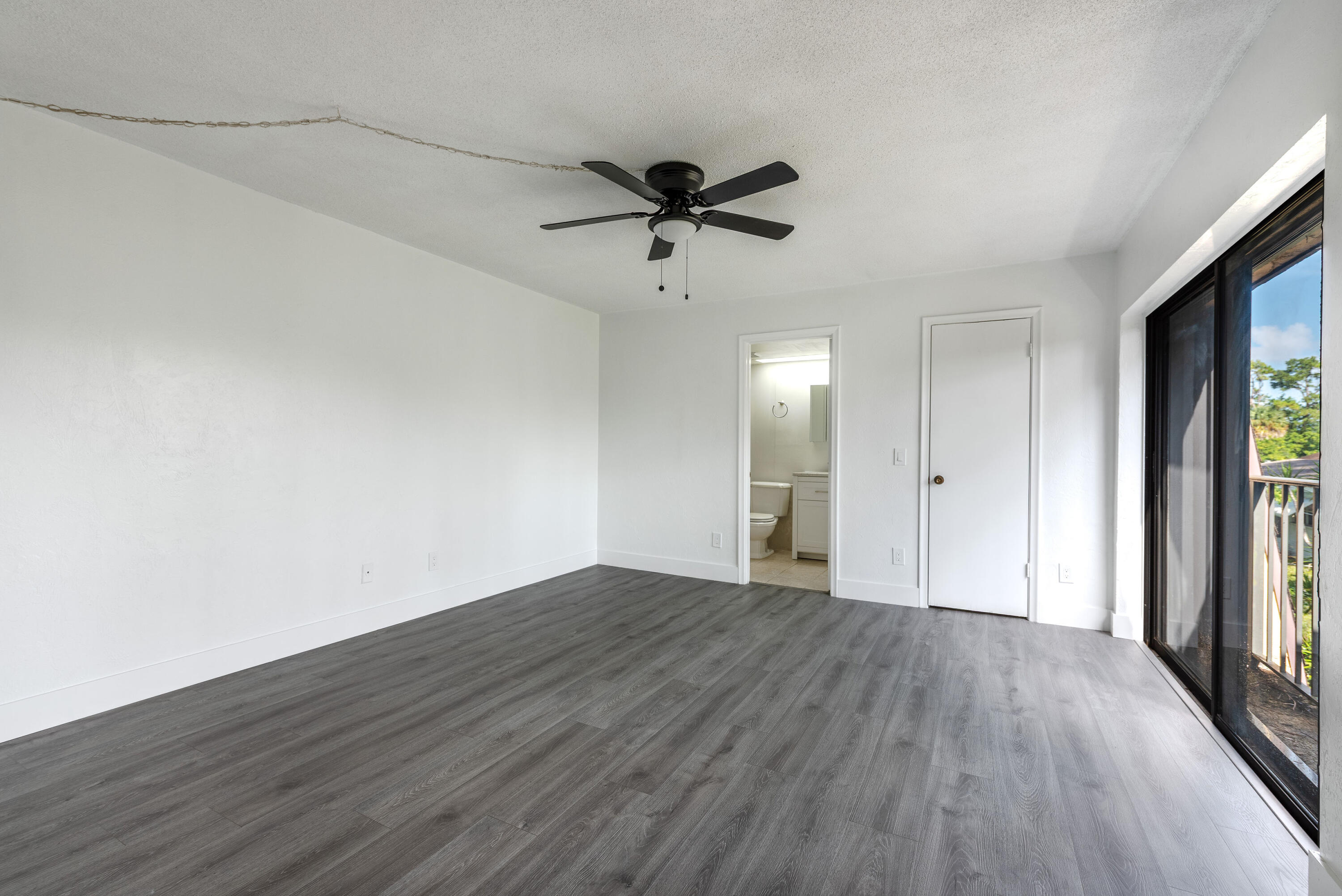 471 Kirk Road, Unit D West Palm Beach, FL 33406 - Photo 16 of 28 wooden floor in an empty room with a window