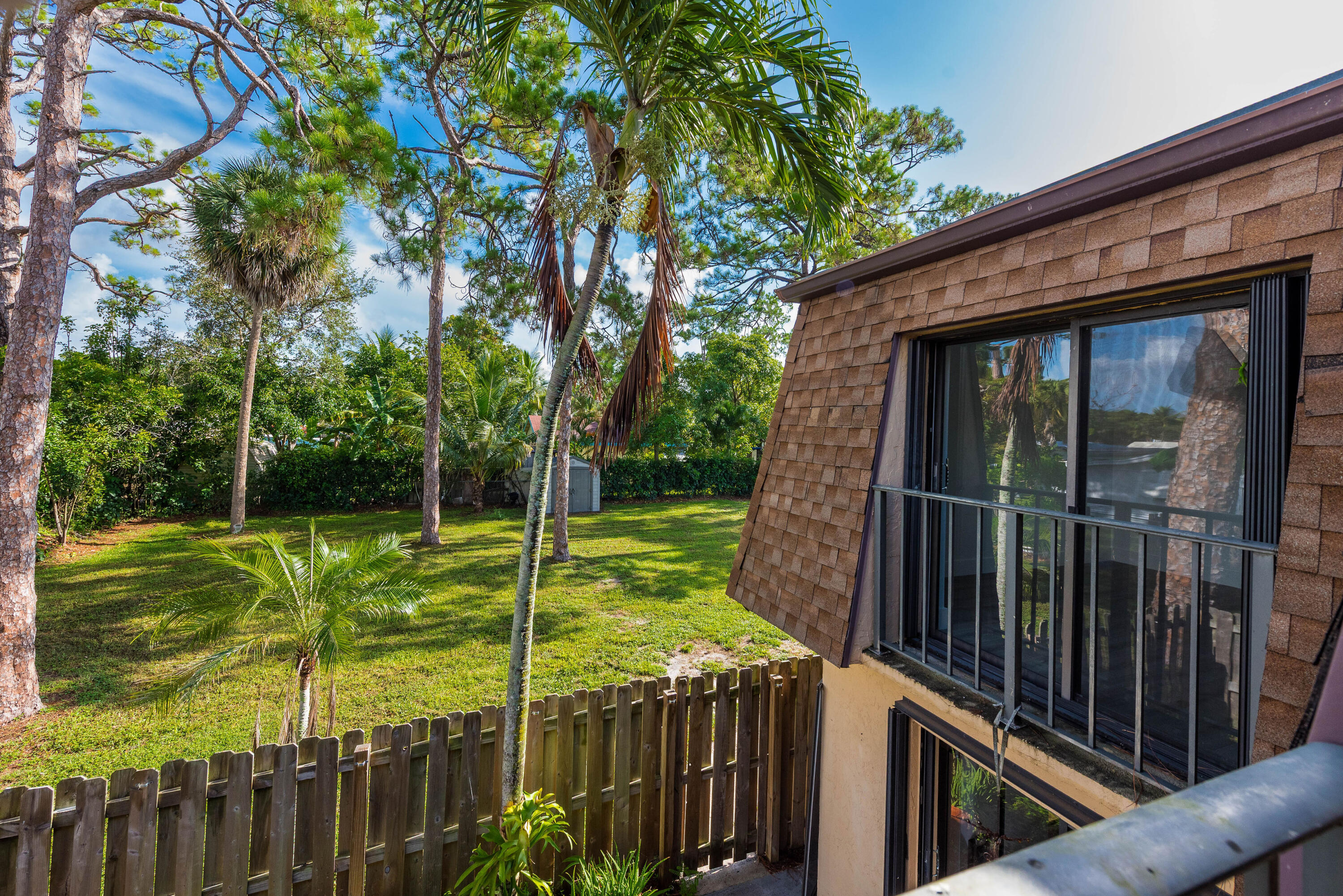471 Kirk Road, Unit D West Palm Beach, FL 33406 - Photo 23 of 28 a view of a backyard with a large tree