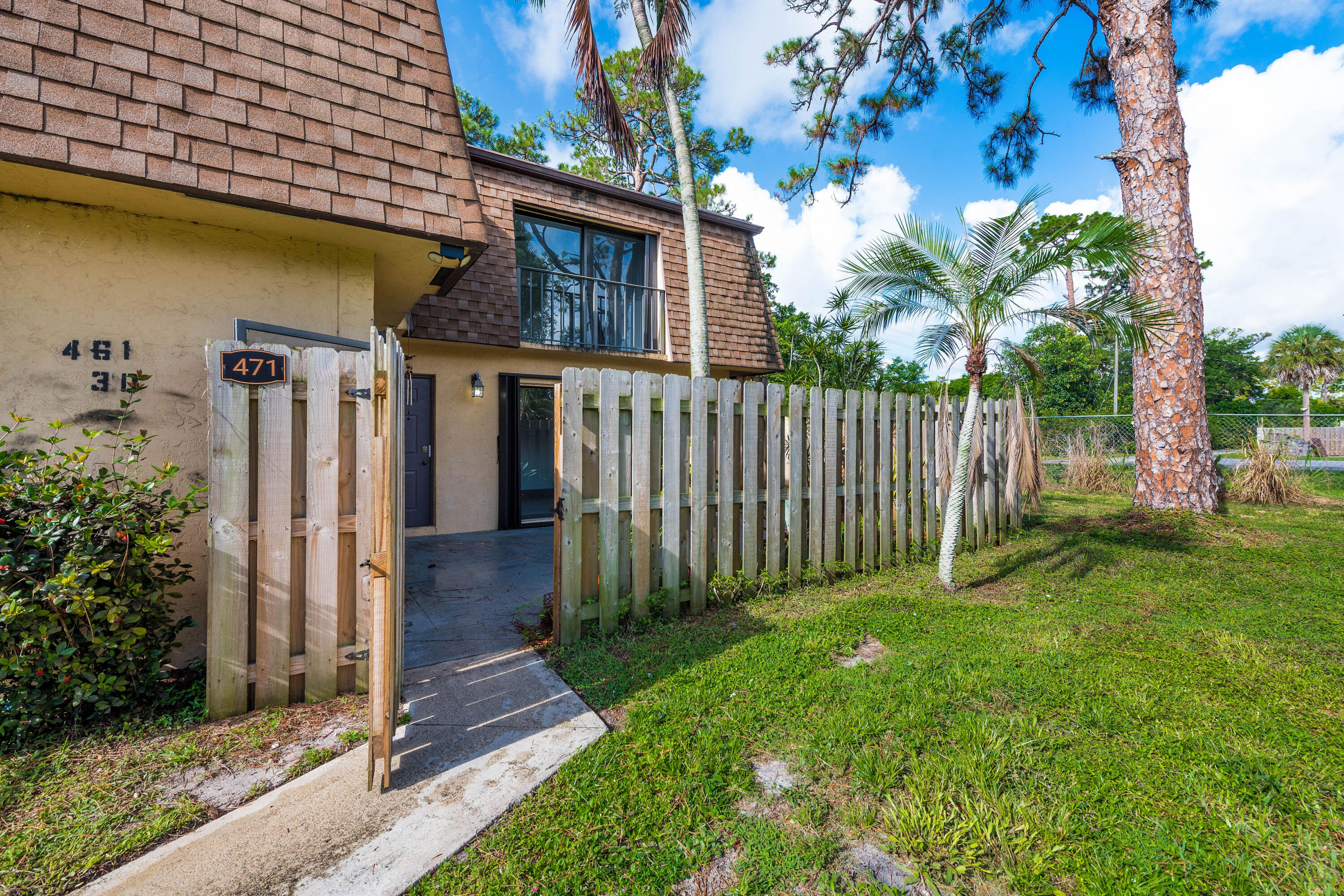 471 Kirk Road, Unit D West Palm Beach, FL 33406 - Photo 25 of 28 a front view of a house with a yard
