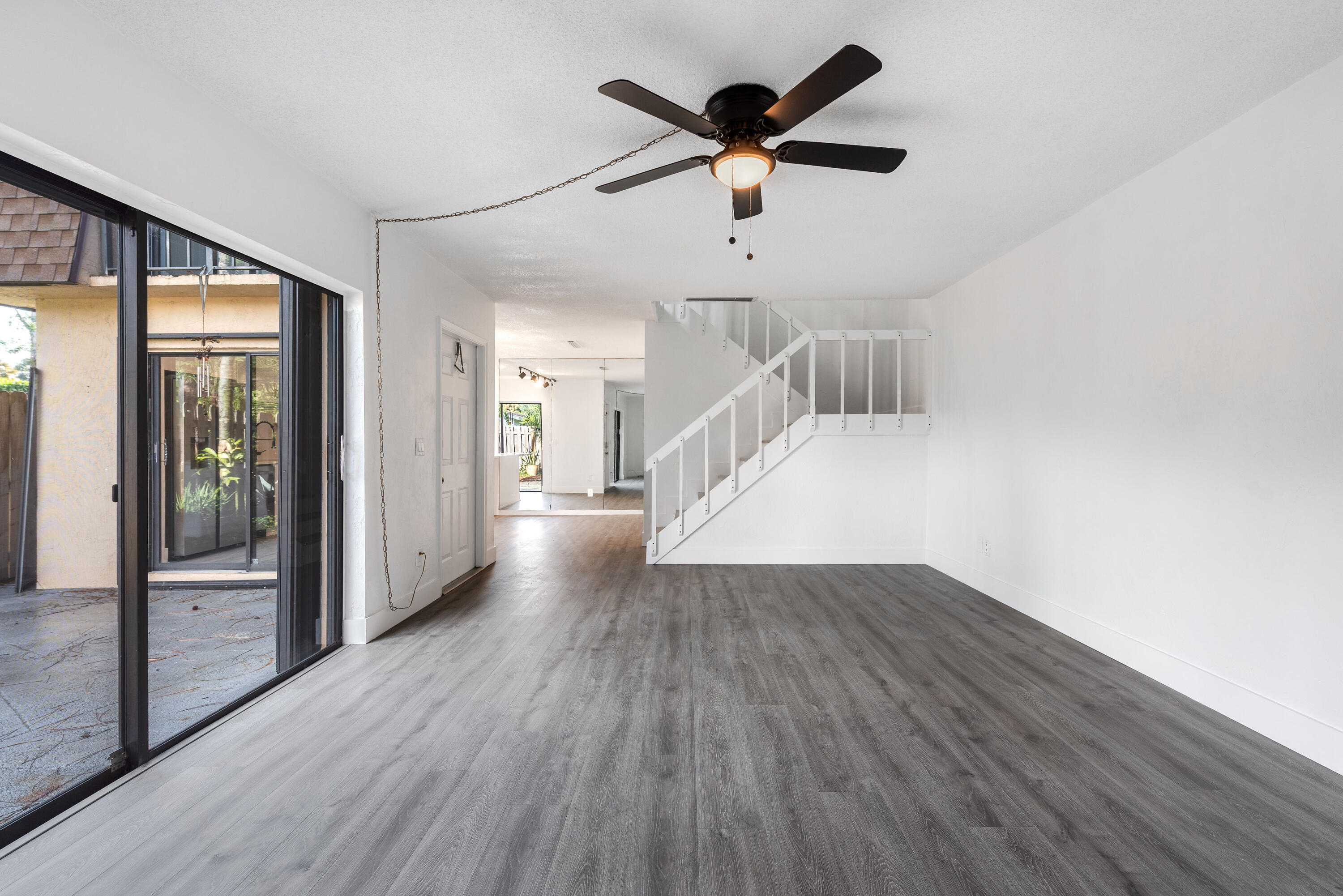 471 Kirk Road, Unit D West Palm Beach, FL 33406 - Photo 5 of 28 wooden floor in an empty room with a window