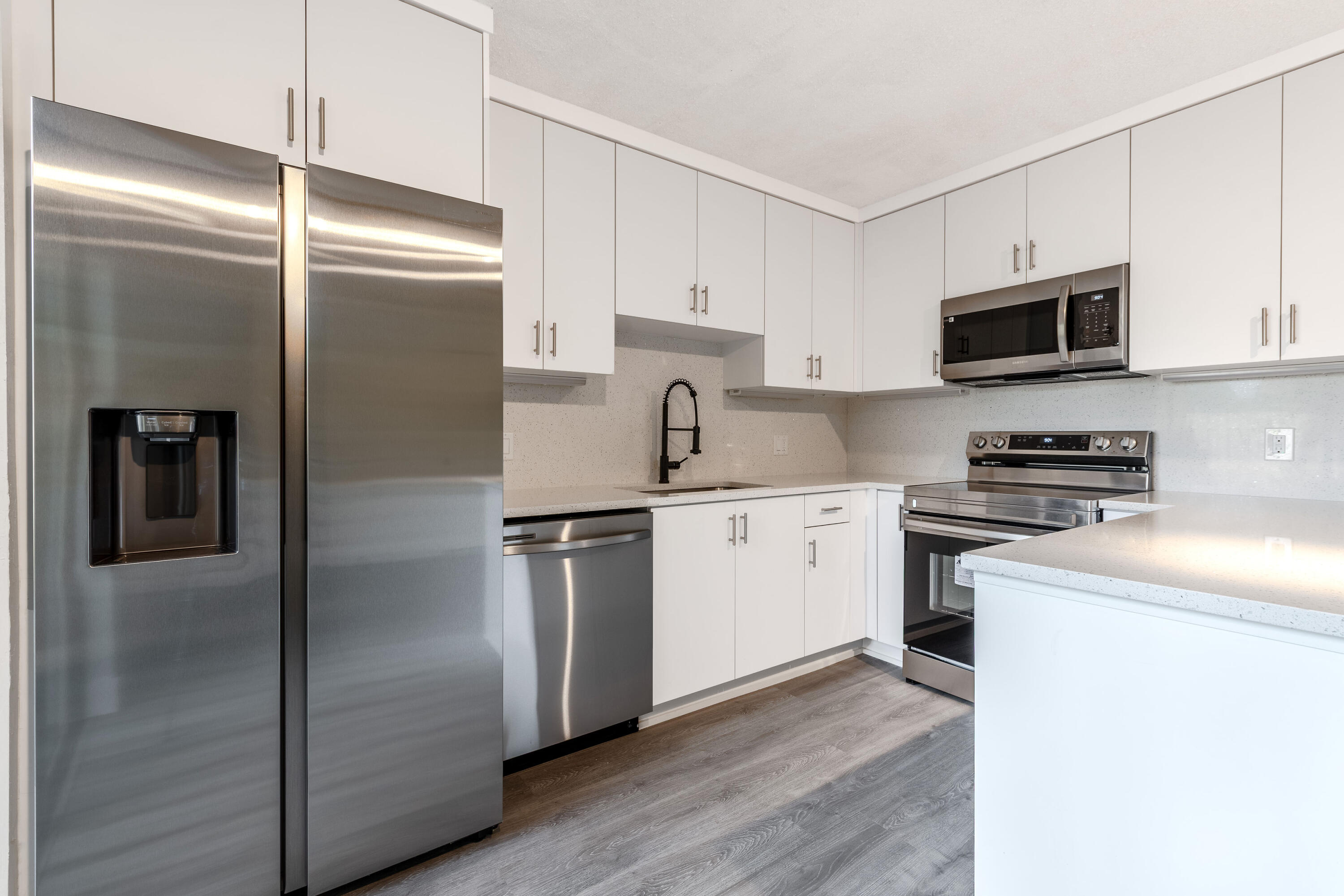 471 Kirk Road, Unit D West Palm Beach, FL 33406 - Photo 8 of 28 a kitchen with a refrigerator stove and sink