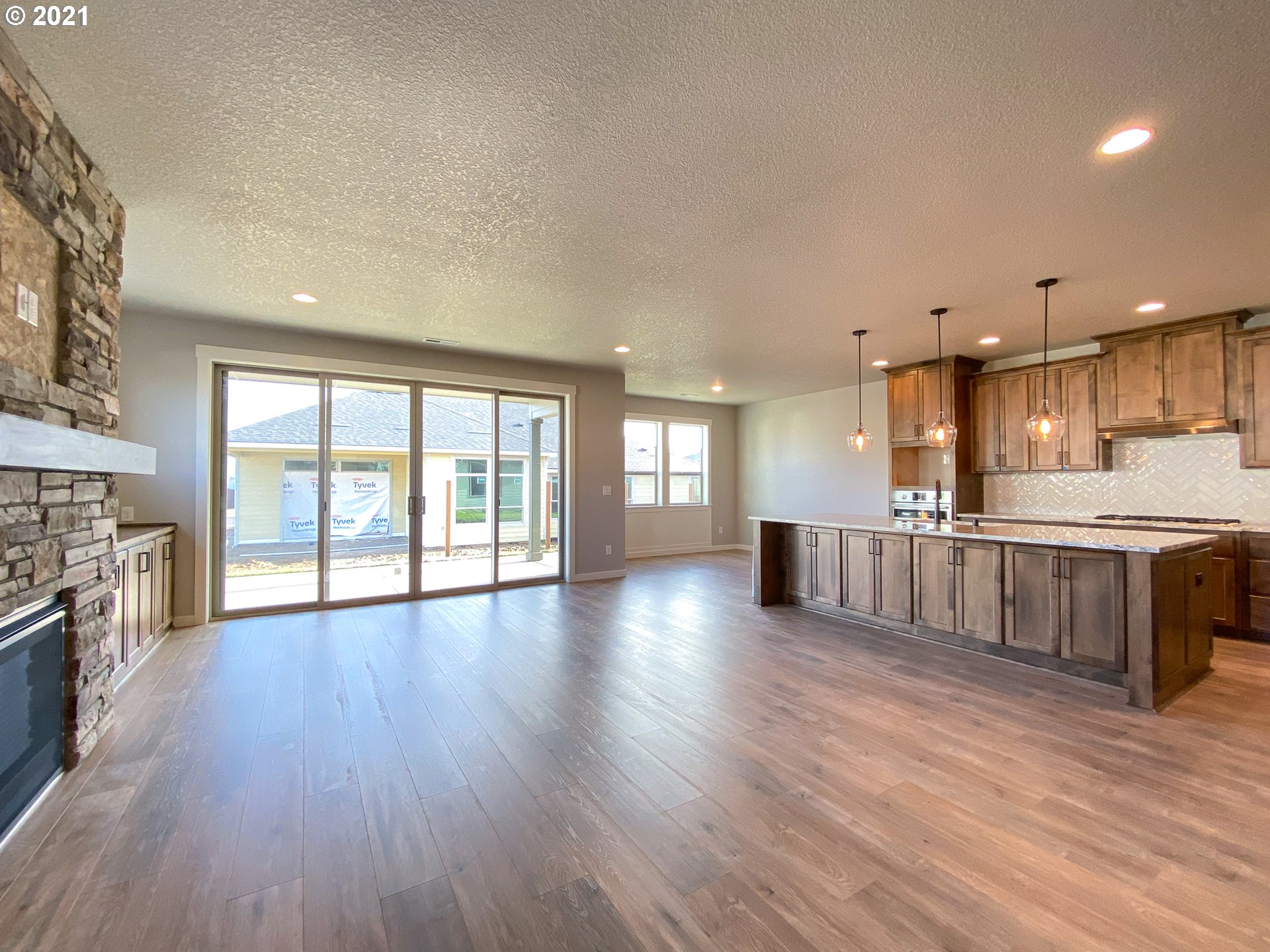 814 South Goose Loop Ridgefield, WA 98642 - Photo 3 of 22 a large kitchen with stainless steel appliances granite countertop a lot of counter space and wooden floor
