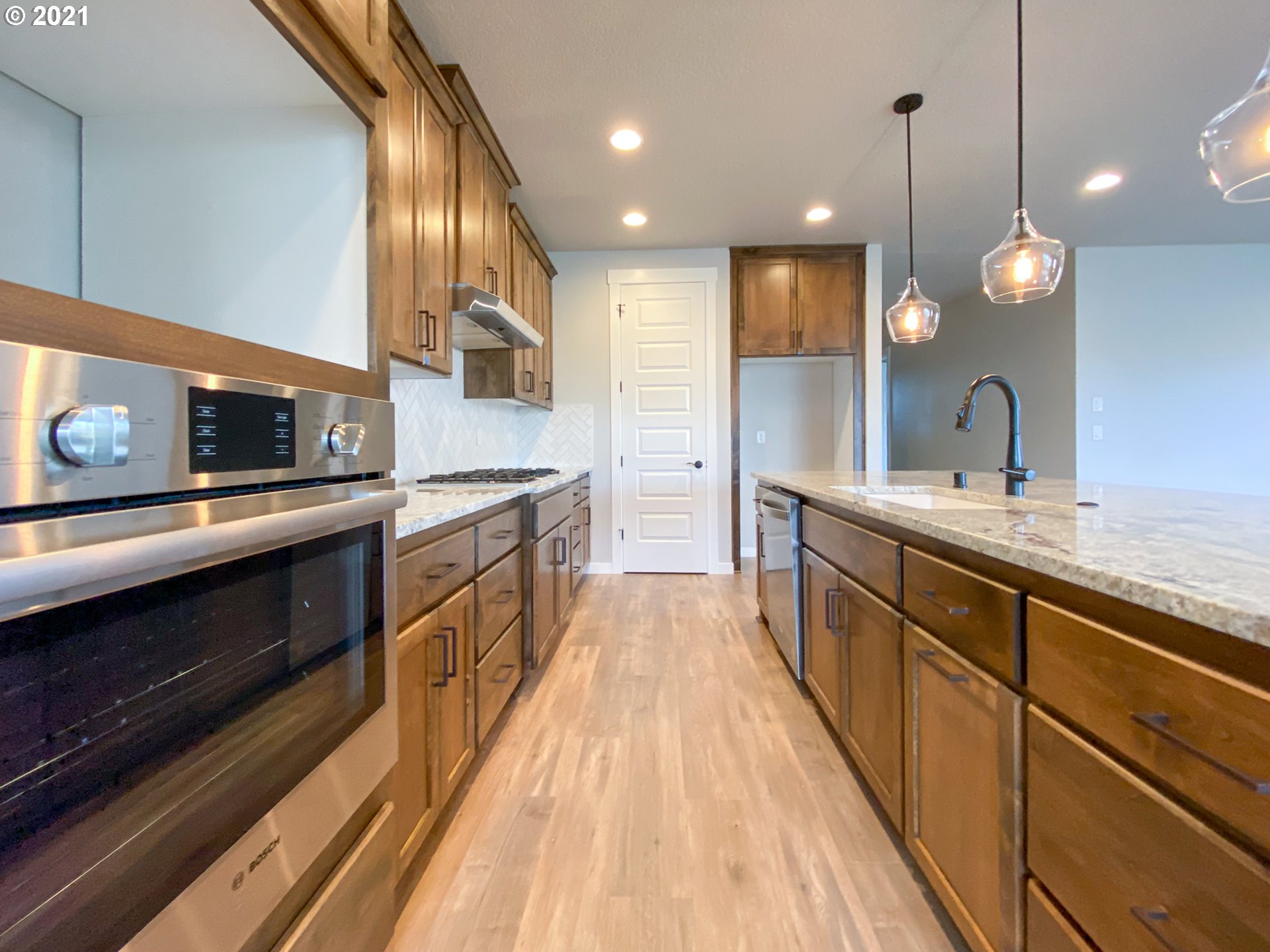 814 South Goose Loop Ridgefield, WA 98642 - Photo 6 of 22 a large kitchen with stainless steel appliances kitchen island a large island in the center