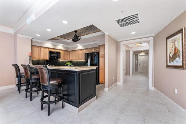 a bedroom with a bed a chandelier and a flat tv