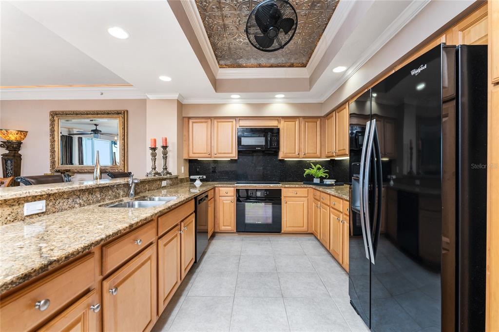 3333 Sunset Key Circle, Unit 506 Punta Gorda, FL 33955 - Photo 16 of 78 a large kitchen with a sink and stainless steel appliances