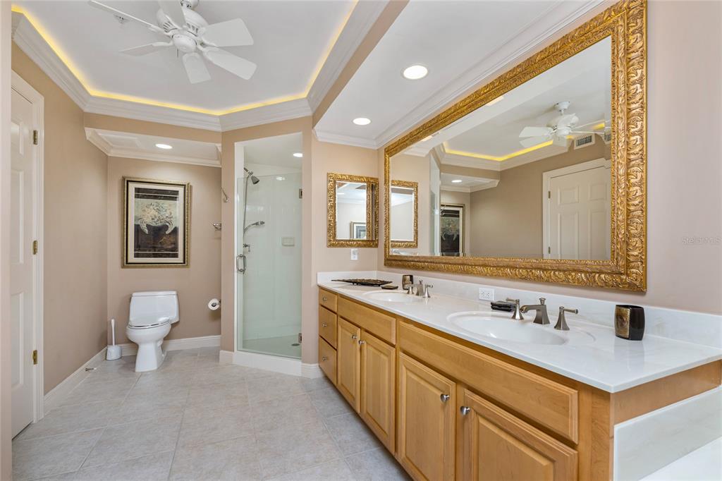3333 Sunset Key Circle, Unit 506 Punta Gorda, FL 33955 - Photo 23 of 78 a spacious bathroom with a double vanity sink a mirror and a toilet